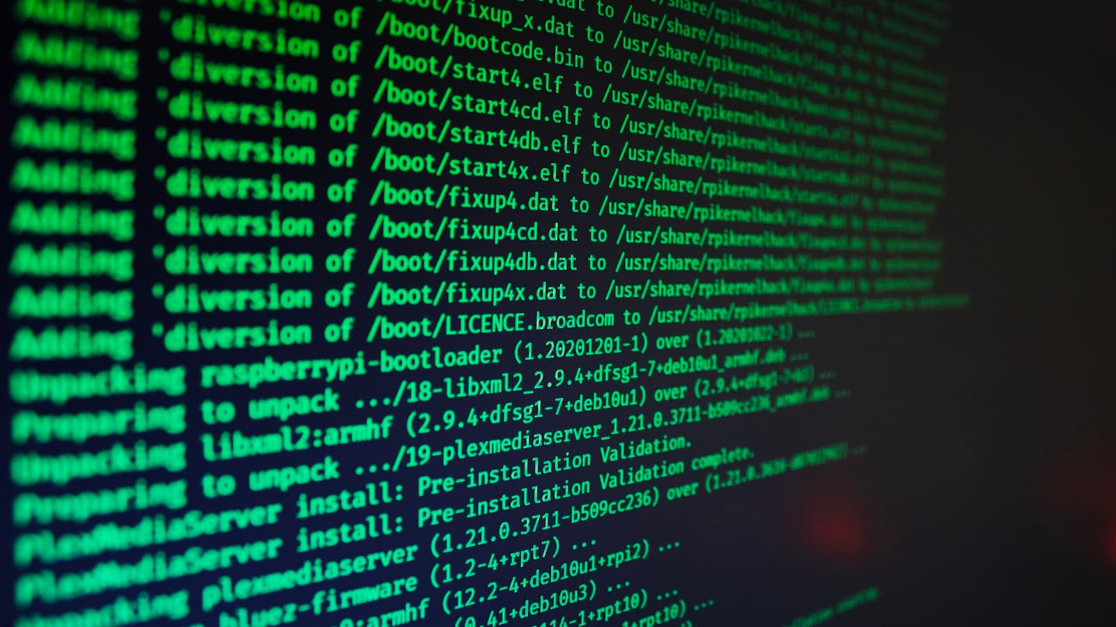 Large monitor displaying code in a dim room